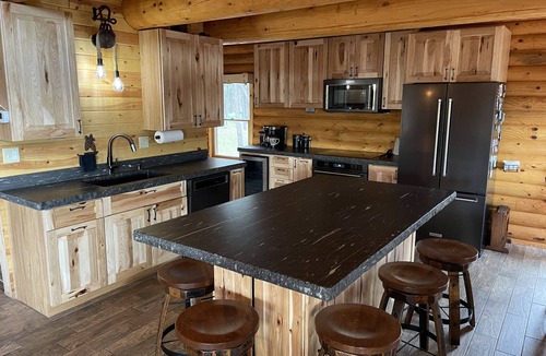 Rapid City House | Rustic, yet comfortable log home with hot tub, sauna, and wood-fired pizza oven.