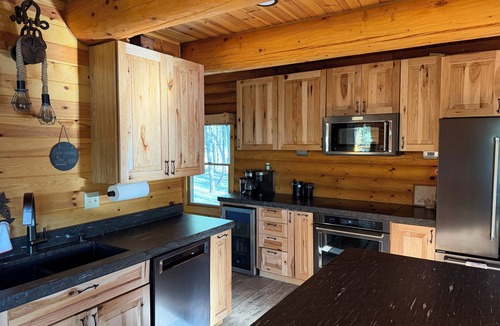 Rapid City House | Rustic, yet comfortable log home with hot tub, sauna, and wood-fired pizza oven.