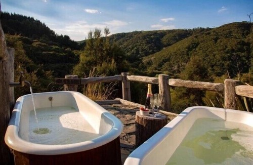 Clutha District House | Secluded Eco-friendly Log Cabin with Steaming Outdoor Baths