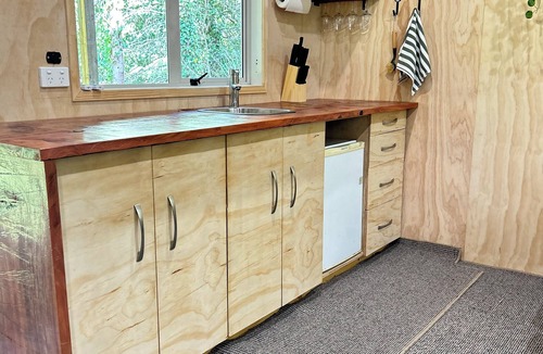 Takapau Cabin | Secluded Redwood Cabin. Built from a redwood tree that blew down in a cyclone