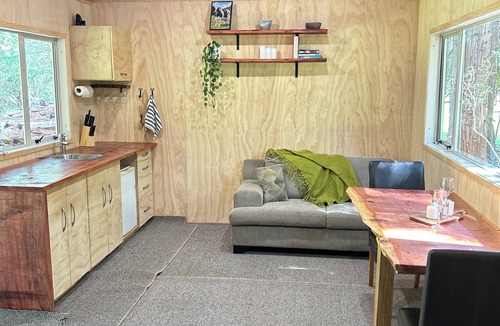 Takapau Cabin | Secluded Redwood Cabin. Built from a redwood tree that blew down in a cyclone