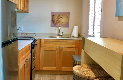 Layton Hotel | Serene Island Studio | Balcony, Pool & Kitchen