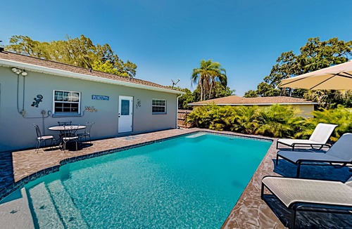 Harbor Bluffs House | Single-story home with outdoor dining, firepit, home office & laundry room