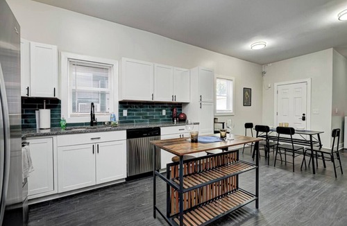 Fountain Square House | Sleeps 6 comfortably: 3 stylish bedrooms with plush bedding and blackout curtains. Music-themed decor: curated vinyls, vintage instruments, and artwork. This short-term rental features bold décor, modern amenities, and walkable access to
