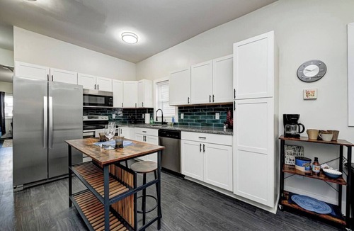 Fountain Square House | Sleeps 6 comfortably: 3 stylish bedrooms with plush bedding and blackout curtains. Music-themed decor: curated vinyls, vintage instruments, and artwork. This short-term rental features bold décor, modern amenities, and walkable access to