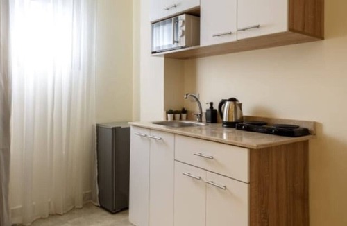 Cairo Apartment | Smart Compact Studio with Convertible Queen Bed , Sofa and Kitchenette and shared community garden