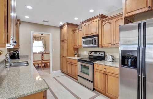 Harbor Hills House | Snowbird friendly elegant home with waterfront location pool grill fireplace