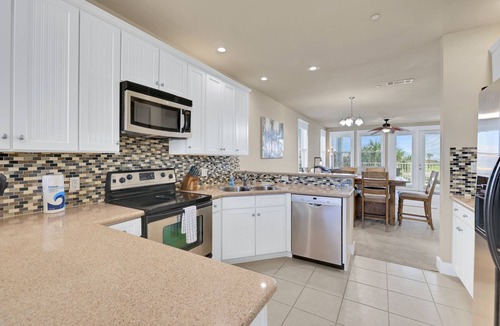 Red Fish Cove House | Spacious beach condo with ocean view, balcony, shared pool & close to the beach