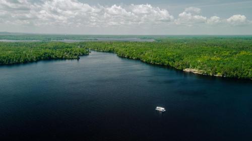 Babbitt Boat Rental | Spacious Cabin-Style Houseboat with Water Slide and Upper Deck Views Near Birch Lake, Babbitt, MN