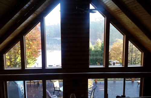 Treasure Lake House | Spacious Lakefront Log Home with large lakefront porch, firepit