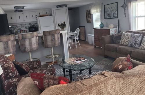 Longmont House | Spacious mobile home with large kitchen/living area and porch with barbeque.