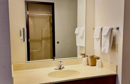 Boulder Junction Apartment | Stay in comfort in this room featuring two queen beds, a private bathroom, sitting area, mini fridge, and single-serve coffee maker. Guests also have access to a microwave in the lobby. Perfect for couples, friends, or families looking for a cozy and