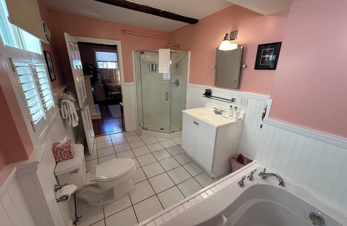 Newport Hotel | Step back in time with modern comfort in this charming exposed beam, private suite in Historic downtown Newport RI! King bed + pull-out sofa, ensuite bath, gas fireplace, AC, TV, mini fridge, coffee station. Steps to Thames Street, shops, wharfs
