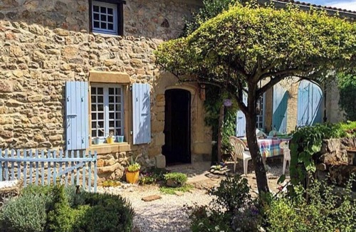 Vion House | Stone house with character, nestled in a verdant setting.
