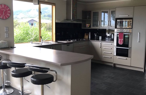Pohara House | Stunning holiday home across the road to the beach