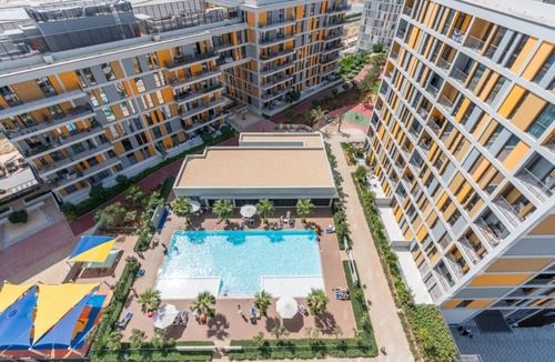 Dubai Production City Apartment | Stylish Noor 3 Studio with Poolside Views