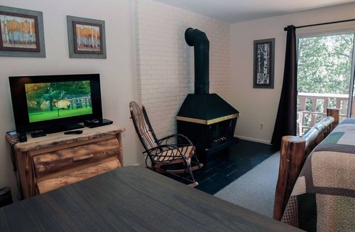 Estes Park Condo | Suite features King bed, full kitchen, and deck with a river view.