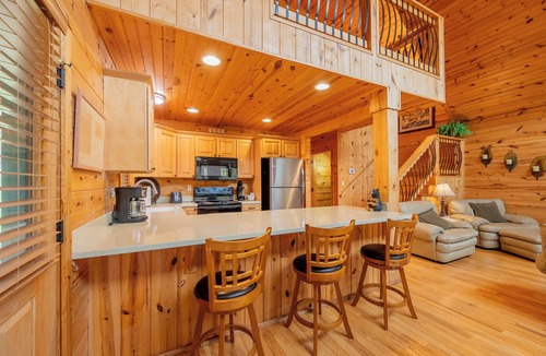 Draper House | Sunny riverside cabin with loft views, big deck, game room, porches, and open lawn.