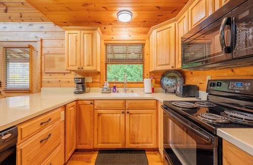 Draper House | Sunny riverside cabin with loft views, big deck, game room, porches, and open lawn.