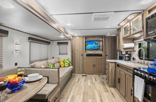 Milton RV Rental | Super- fun camper with plenty of room for a full-size family, lots of comfy beds + full kitchen, bath, and separate bedroom for Mom & Dad. There's even a nice patio with outdoor kitchen and seating area for barbecues, bacon & eggs in the morning, et