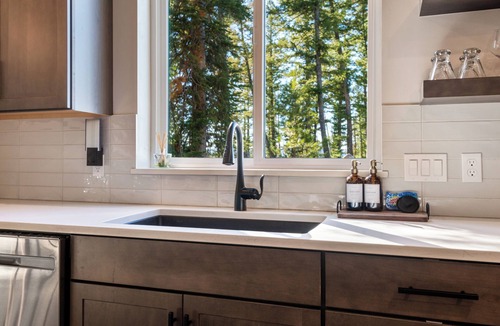 Philipsburg House | The Basin is a modern, luxury cabin nestled in the pines at the base of Discovery Ski Hill. Enjoy panoramic views of the surrounding forest and the relaxing sounds of a nearby creek while relaxing by a smokeless fire in the Solo stove on the deck.