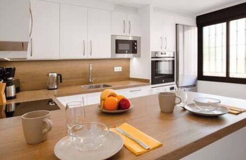 La Capellania Apartment | This seaside apartment is perfect for relaxation with its terrace offering sea views and soothing wave sounds. It features two bedrooms, two fully equipped bathrooms, a spacious living room, and a kitchen. Enjoy meals or sunbathe on the loungers
