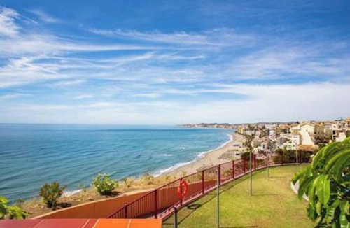 La Capellania Apartment | This seaside apartment is perfect for relaxation with its terrace offering sea views and soothing wave sounds. It features two bedrooms, two fully equipped bathrooms, a spacious living room, and a kitchen. Enjoy meals or sunbathe on the loungers
