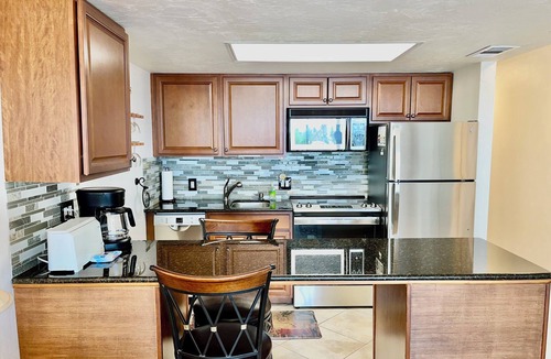 Vanderbilt Beach Condo | TOP FLOOR BAY VIEW, ROOFTOP POOL, STEPS TO VANDERBILT BEACH!