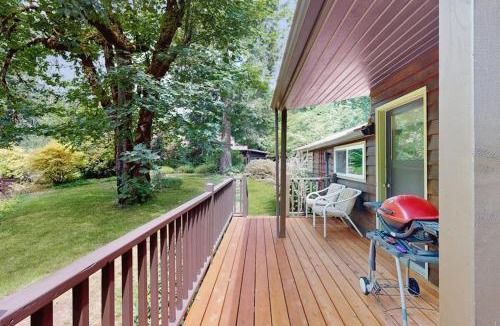 Molalla House | Tranquil landscape with riverside firepit gas grill gas fireplace and deck