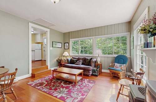 Molalla House | Tranquil landscape with riverside firepit, gas grill, gas fireplace, and deck