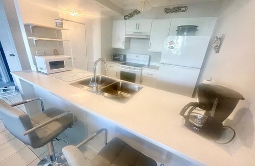 Williams Town Condo | Tropical Oasis: Ocean View ~ Pool & Bar ~ Family-Friendly
