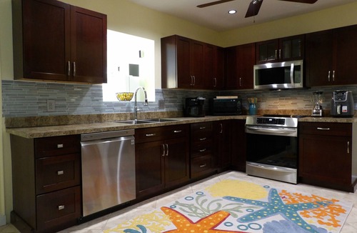 Singer Island House | Tropical Paradise Home Steps to Beach Heated Pool Game Rm Singer Island Retreat!