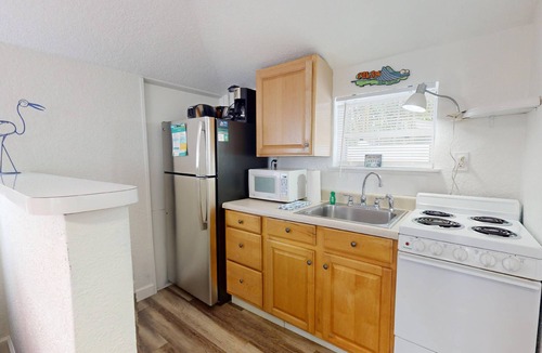 Madeira Beach Cottage | Unwind in Studio Cottage, Steps From the Beach, Heated Pool and a Short Walk to Johns Pass Village.