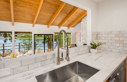 Rollingbay House | Updated beachfront home with private beach, water views, spacious deck, & W/D