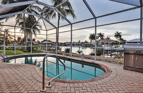 Naples House | Upscale waterfront home with private dock, saltwater pool, lanai, grill, & W/D