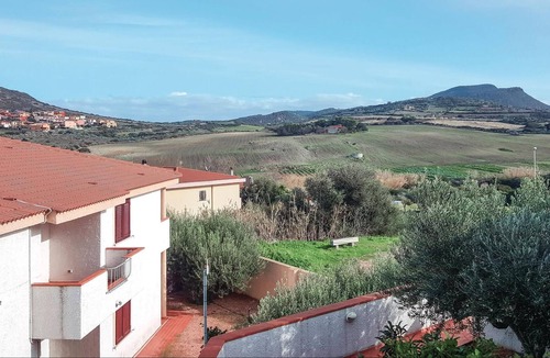 Lu Bagnu Apartment | Vacation apartment on the 1st floor with shared pool 500 m from the sea in Lu Bagno.