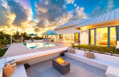 Caicos Islands Villa | Wakesurf Villa Waterfront Retreat with Dock Kayaks and Pool