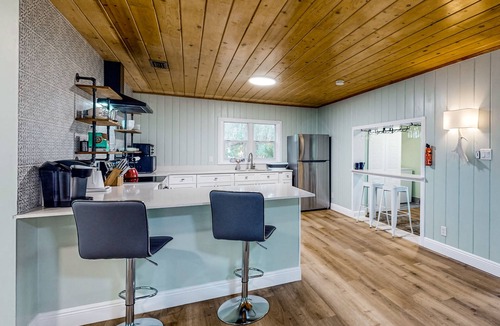 Candler House | Waterfront stay with a dock, firepit, grill, sunroom, separate studio, W/D, & AC