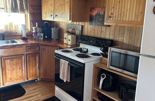 South Boardman Cabin | Welcome to Serenity Shores! 🌅 Soak in the private hot tub, unwind by the fire pit 🔥, and savor calming lake views. Pet-friendly 🐾 and perfect for recharging, exploring, and making memories.