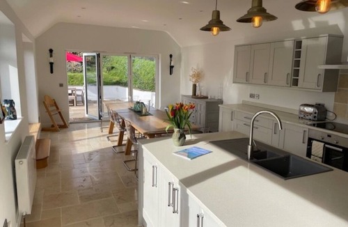 Malborough House | Windrush, Malborough. A spacious family home with a large patio and garden