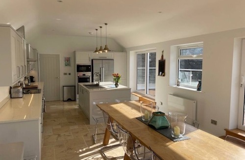 Malborough House | Windrush, Malborough. A spacious family home with a large patio and garden