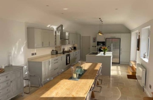 Malborough House | Windrush, Malborough. A spacious family home with a large patio and garden