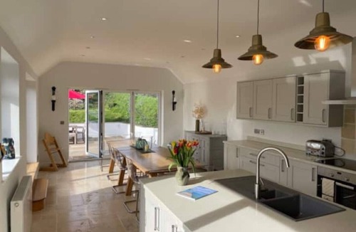Malborough House | Windrush, Malborough. A spacious family home with a large patio and garden