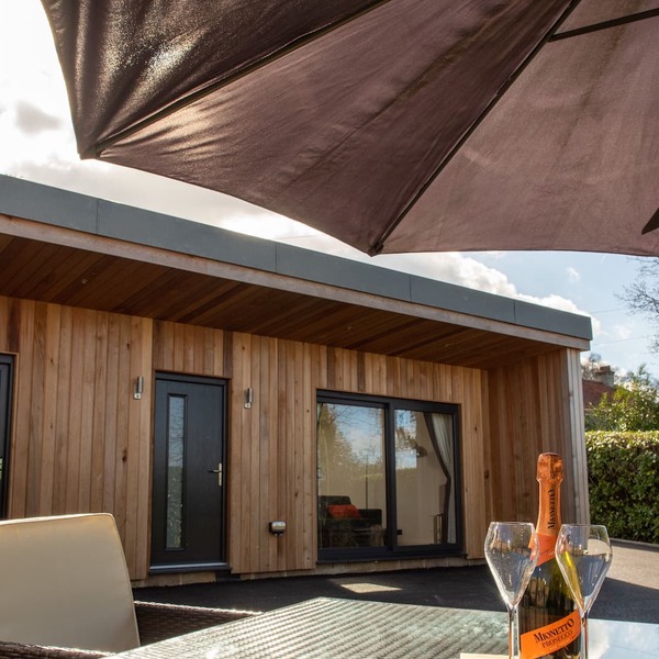A contemporary cedar clad lodge adjacent to a national cycle route