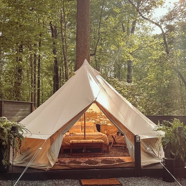 A luxurious glamping tent nestled in the trees.