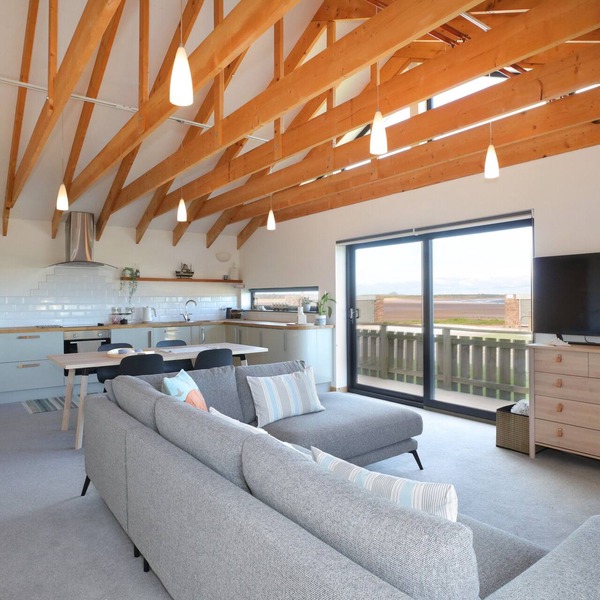A modern, seafront chalet offering stunning beach views of Belhaven Bay.