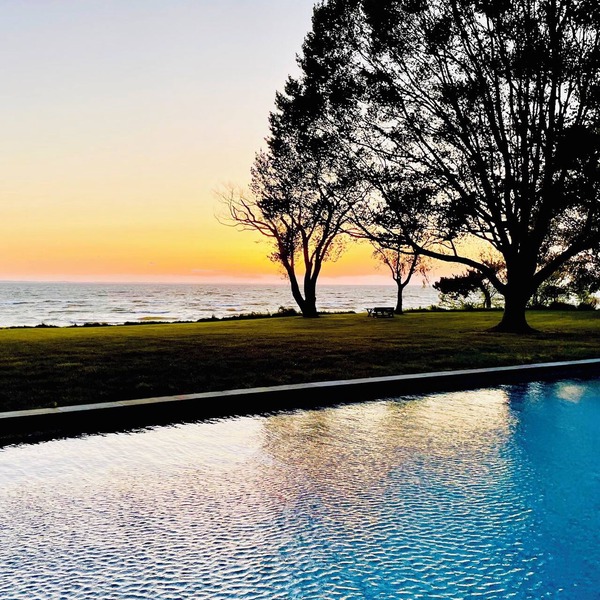 A stunning Chesapeake Bay sunset from a beautiful home with an inground pool!