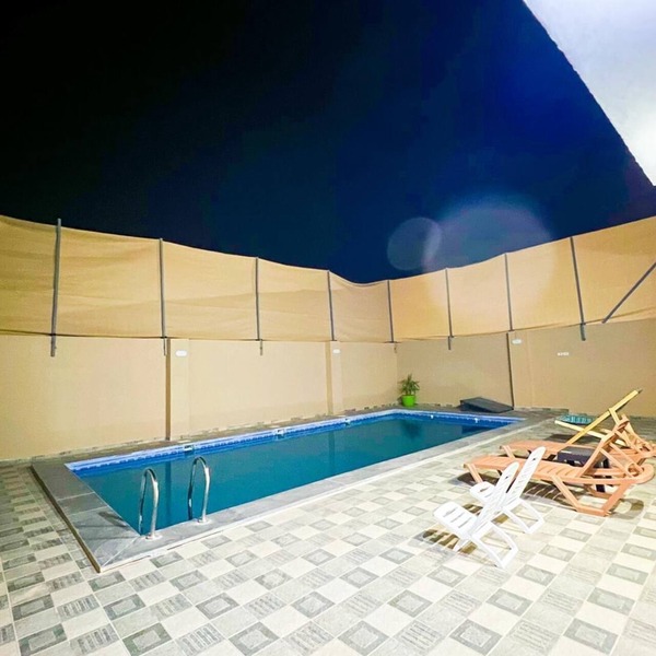 Cheerful two bedrooms villa with warm pool, playground,& specious sitting room.