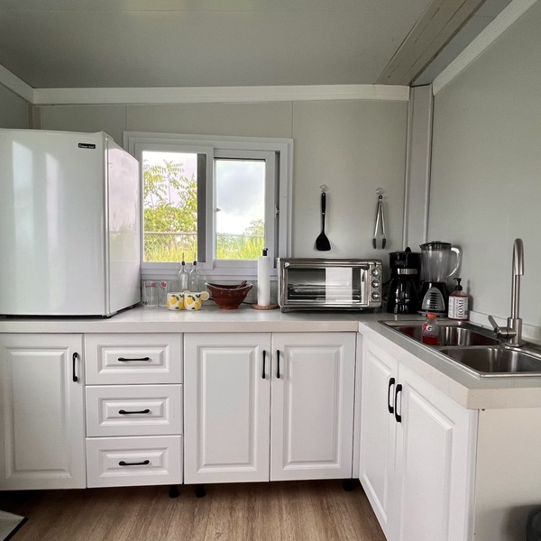 Comfy and cozy mini house sitting on a beautiful 1500 meter lot. Great location!