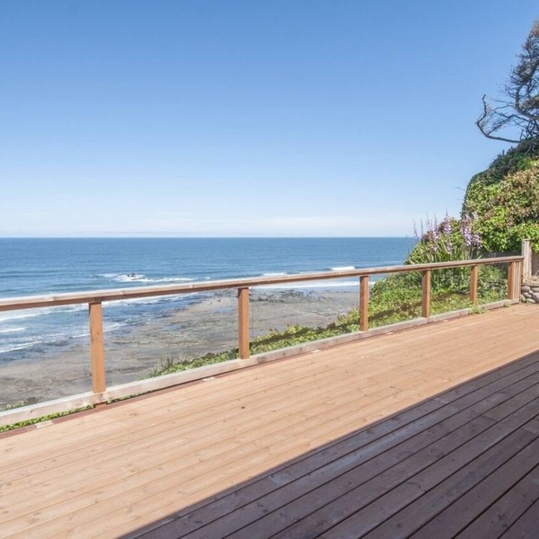 Dramatic oceanfront views. Open high ceilings. Huge deck & walls of windows!